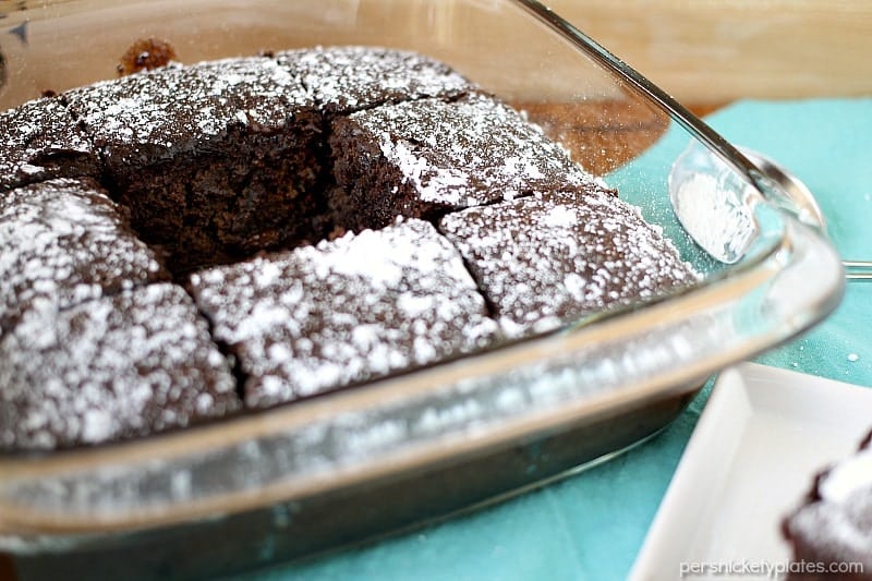 chocolate cake in glass baking dish with center piece missing