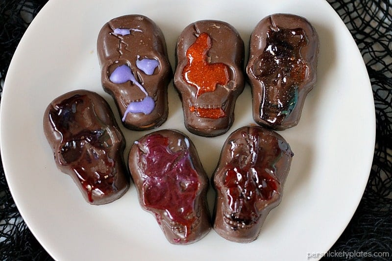 Peanut Butter Butterfinger Skull Cookies start with a soft and chewy from scratch peanut butter cookie then are topped with a spooky, decorated Butterfinger Peanut Butter Skull Cup. Perfect for any Halloween party! | www.persnicketyplates.com