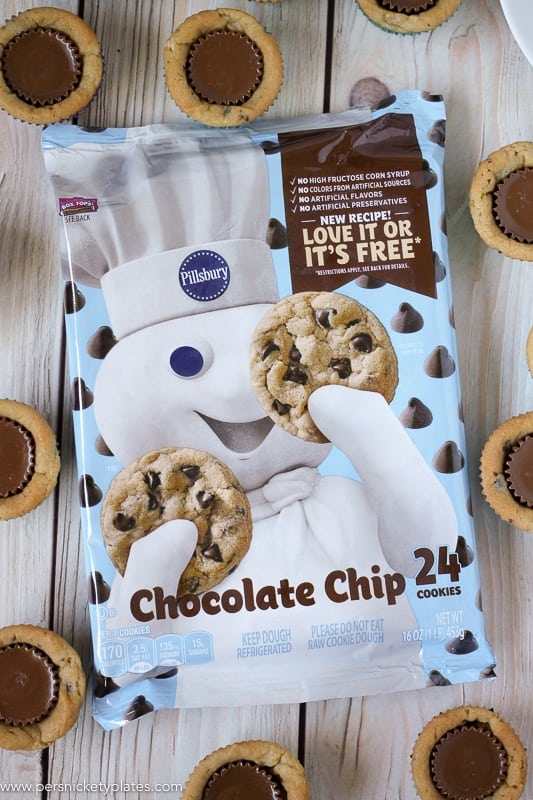 Chocolate Chip Peanut Butter Cookie Cups are only two ingredients and are ready in just 20 minutes. Perfect for a last minute bake sale, class treat, or craving! | www.persnicketyplates.com #easydessert #cookie #cookiecups #semihomemade #dessert pilsbury chocolate chip cookie dough package surrounded by cookie cups