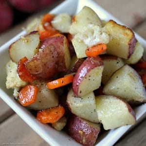 Garlic Roasted Veggies are a mix of cauliflower, carrots, and red skin potatoes tossed in olive oil and garlic and roasted to perfection. | www.persnicketyplates.com