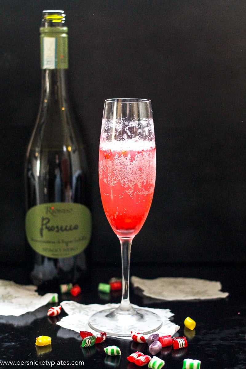 This Cranberry Prosecco Spritzer combines the vibrant bubbles of Riondo Prosecco with the warm winter notes of spearmint and cranberries. It's the perfect accompaniment to wrapping gifts and spending time with family and friends around the fire or in the kitchen. | www.persnicketyplates.com