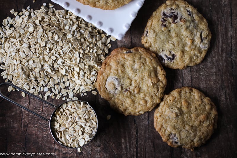 ranger cookies on wood table with spilled oats.