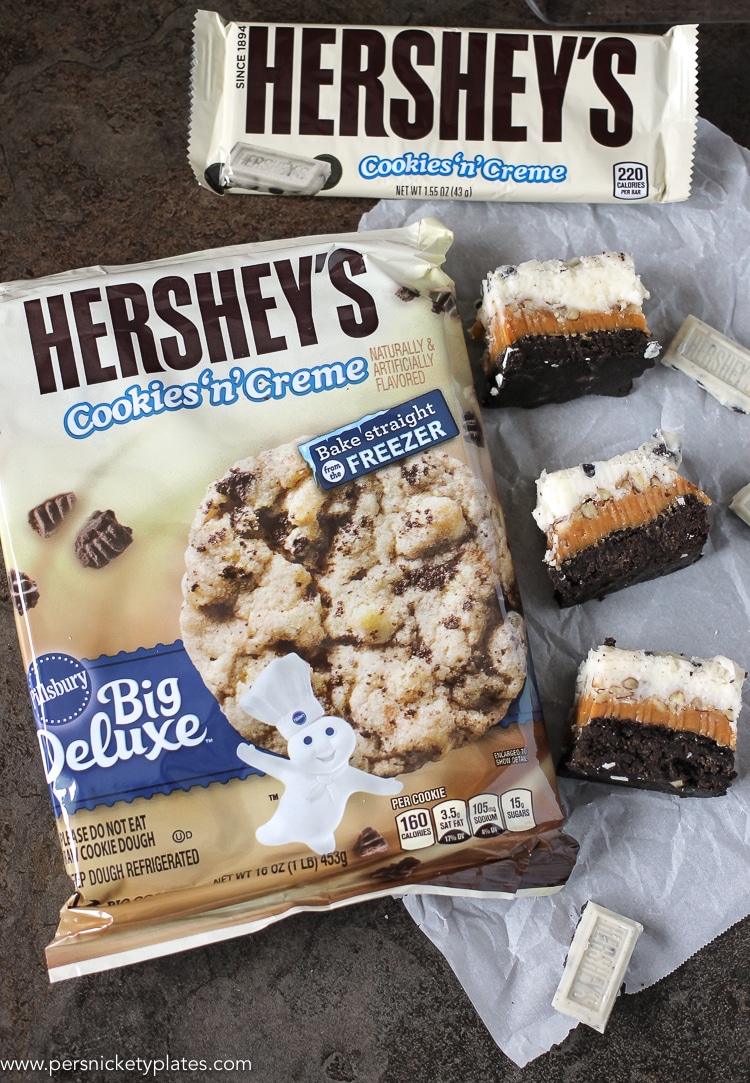 Cookies and Cream Caramel Layer Bars start with a layer of Pillsbury Cookies 'n Creme cookie dough, topped with a layer of caramel, chopped pecans, frosting, then finished with melted Cookies 'n Creme candy bars. I hope your sweet tooth is ready! hershey's cookies 'n creme refrigerated cookie dough
