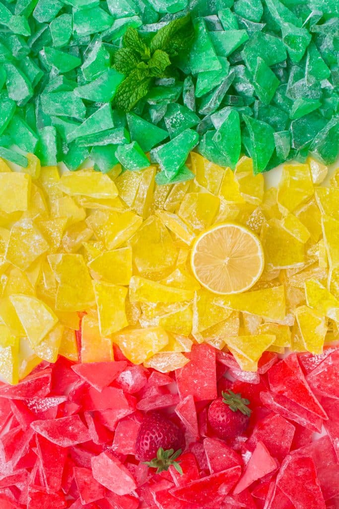 overhead shot of green, yellow, and red hard candy. 
