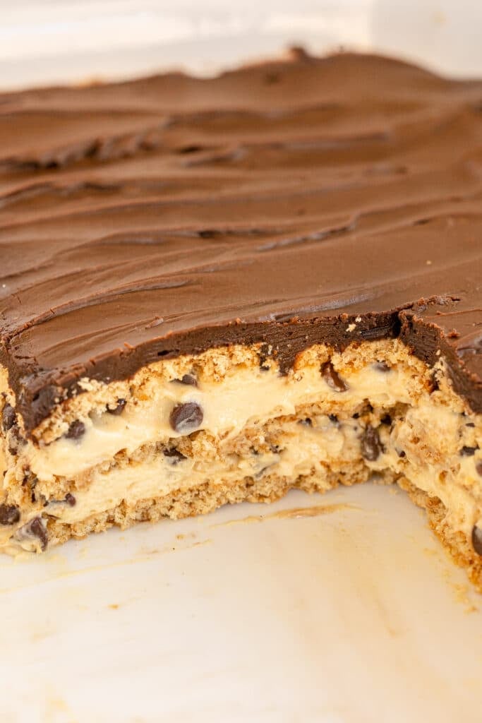 side view of layered chocolate eclair dessert in a baking dish.