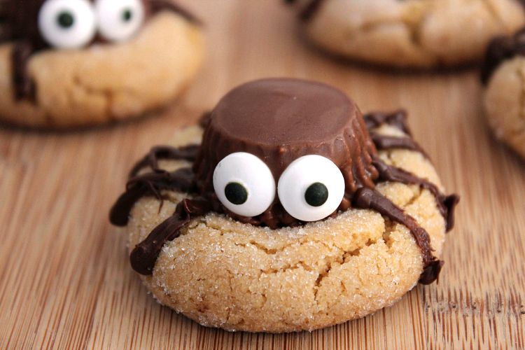 peanut butter cookie with reese's cup spider on top