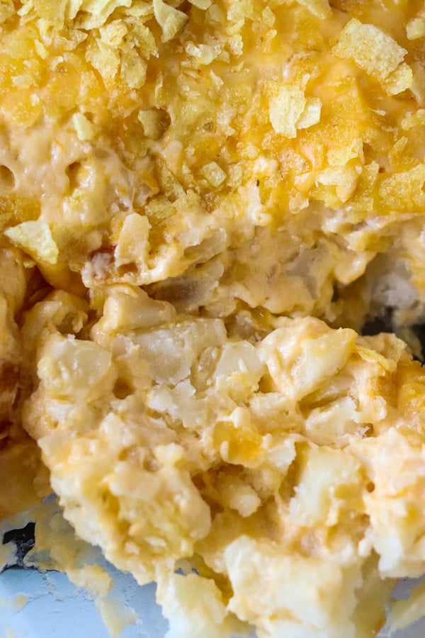 close up of cheesy potato casserole topped with chips