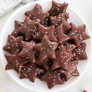 platter of shortbread cookies coated in chocolate with christmas sprinkles