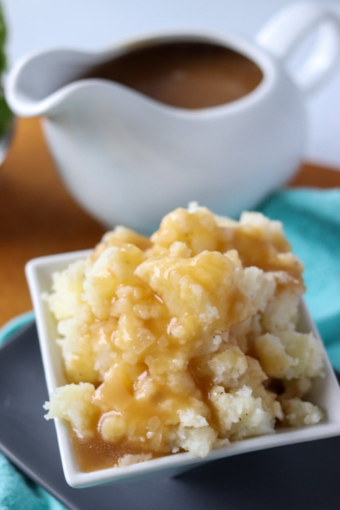 mashed potatoes & gravy in a white dish