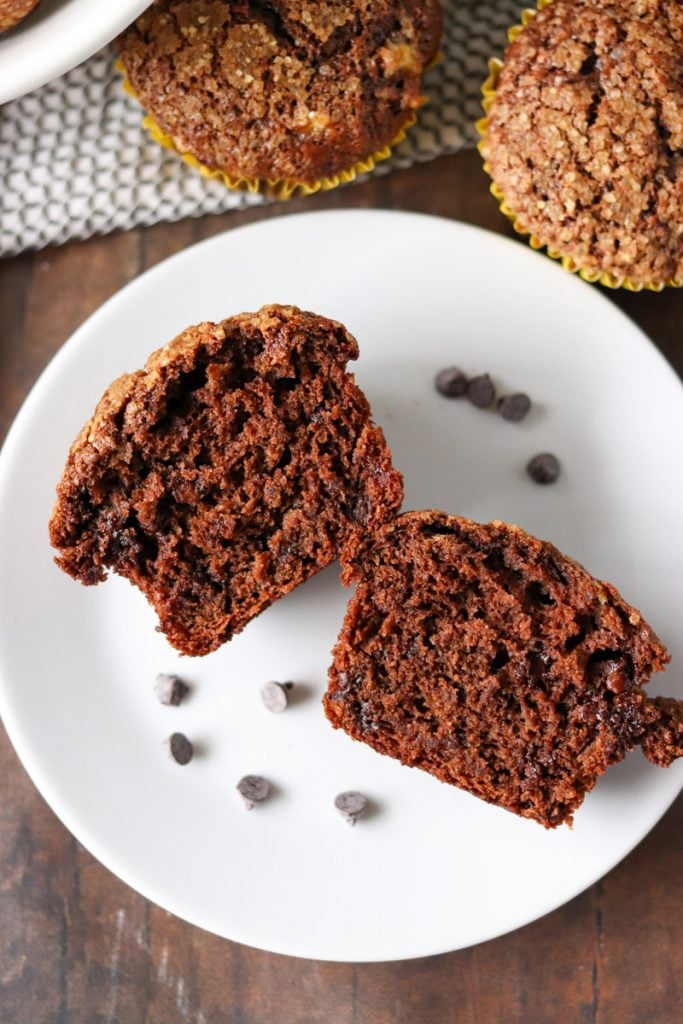 sliced chocolate banana muffin on a white plate.