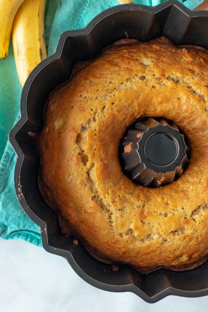 overhead shot of orange banana bundt cake in pan