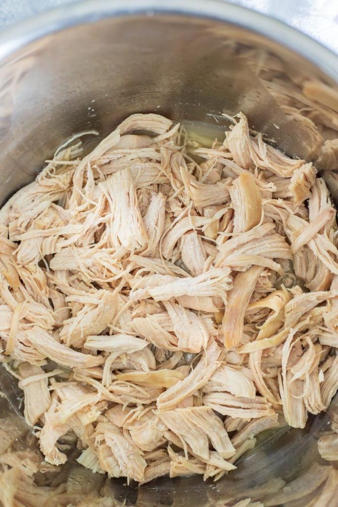 overhead shot of shredded chicken in an instant pot basin