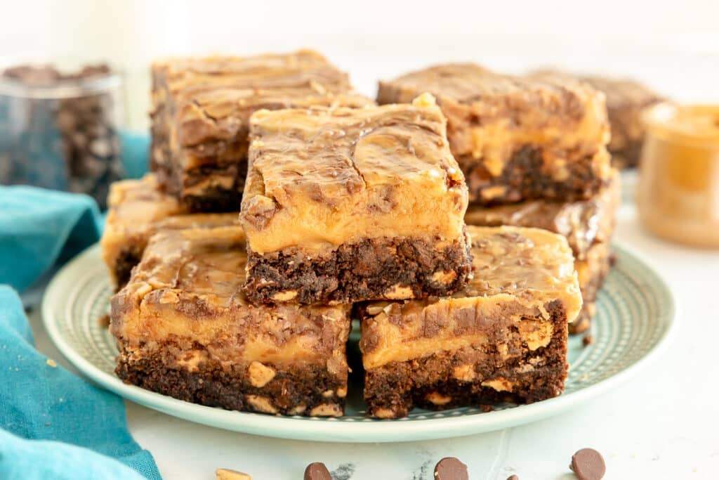stack of peanut butter brownies on a plate.