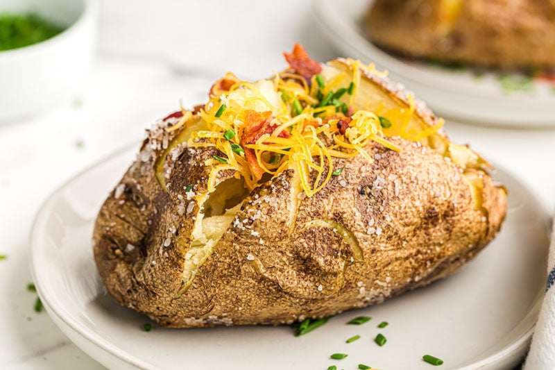 loaded baked potato topped with cheese & bacon & chives