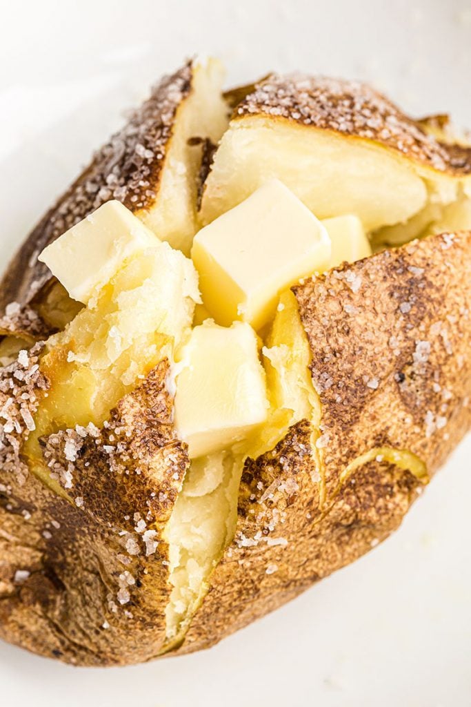 baked potato topped with butter squares