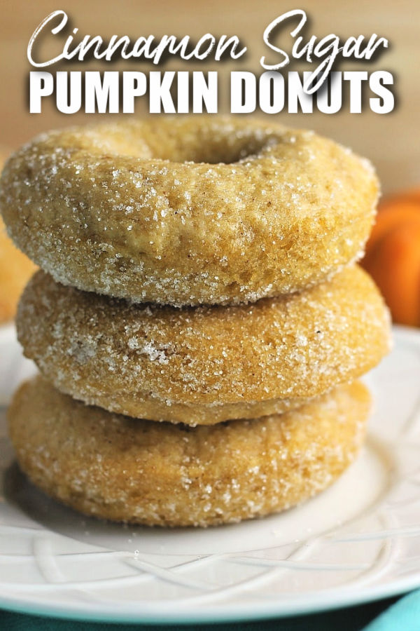 stack of 3 donuts on a white plate with text reading cinnamon sugar pumpkin donuts