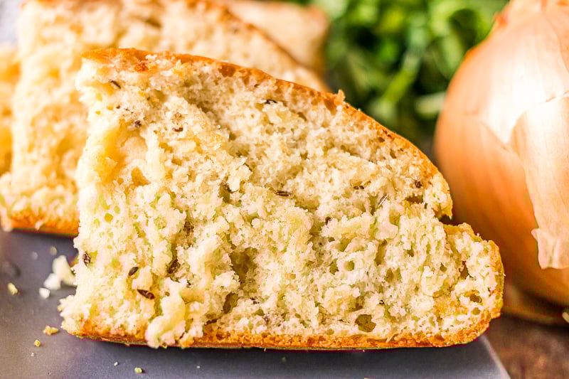close up of slice of onion dill bread