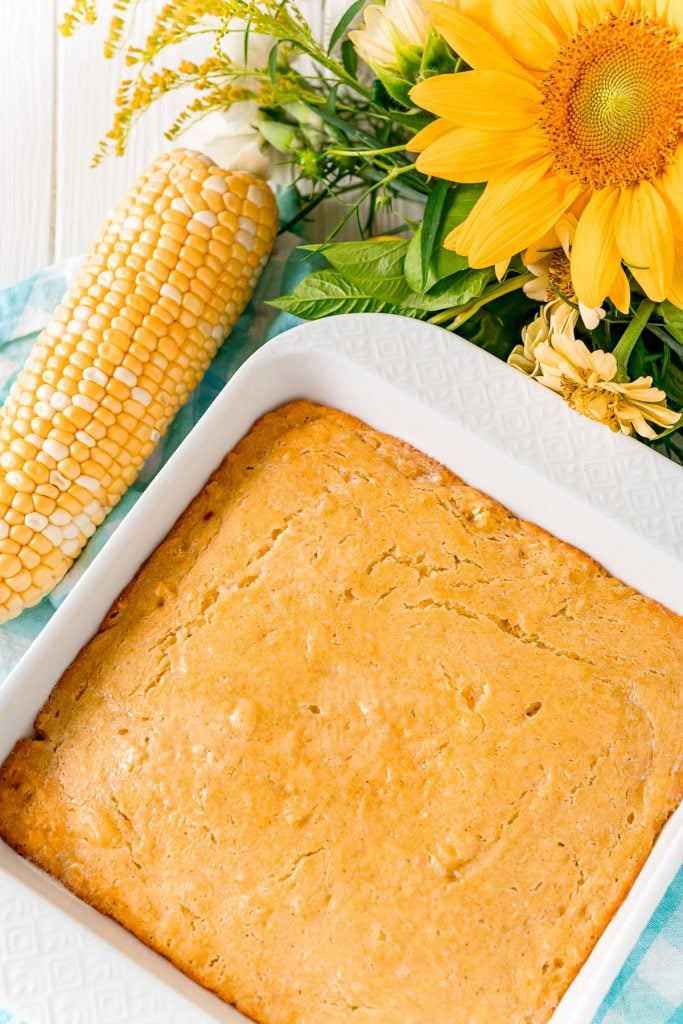overhead shot of cornbread in baking dish next to corn cob