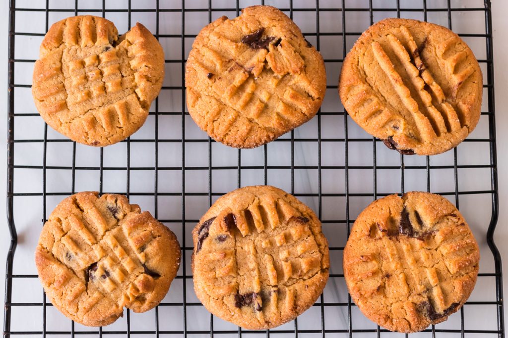 overhea shot of peanut butter chocolate chip cookies on a cooling rack