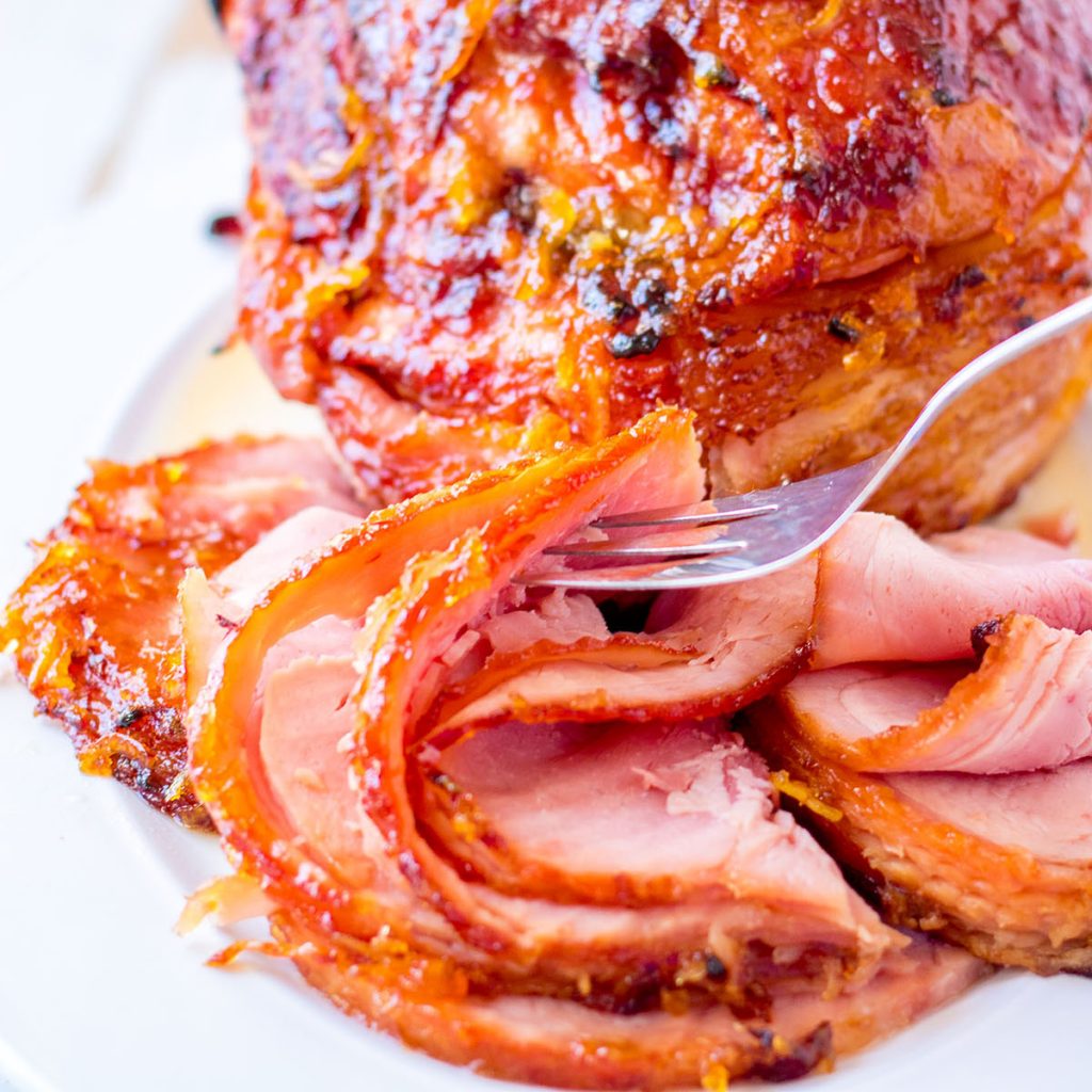 fork picking up a slice of spiral sliced ham