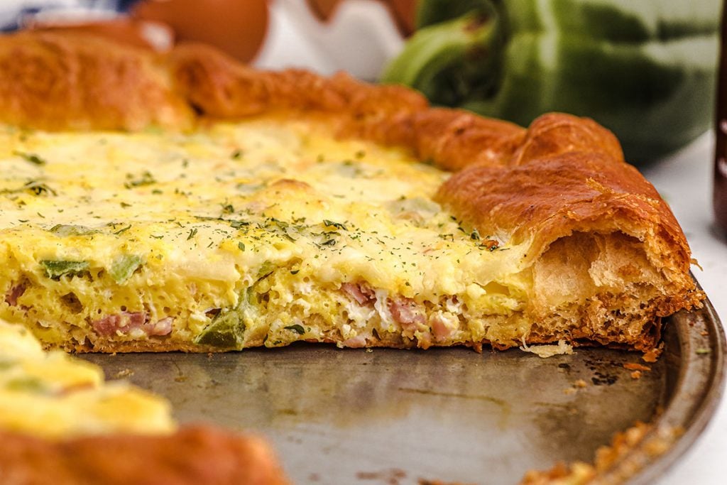 side view of a slice of breakfast pizza