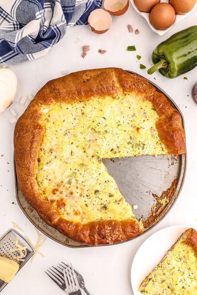 overhead shot of a breakfast pizza with a missing slice