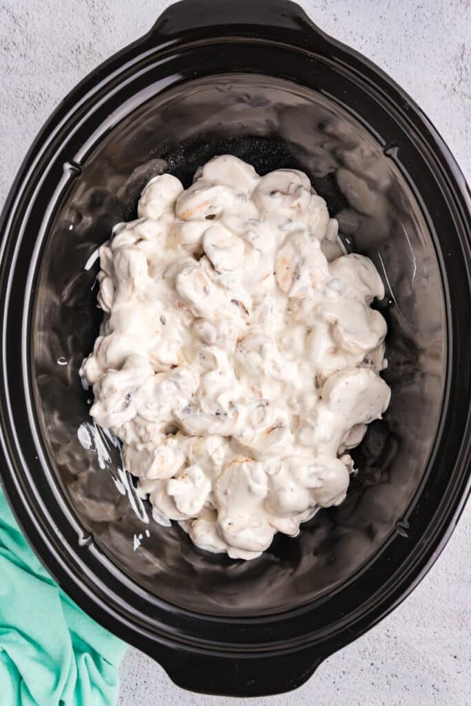 overhead shot of creamy mushroom sauce in a slow cooker.