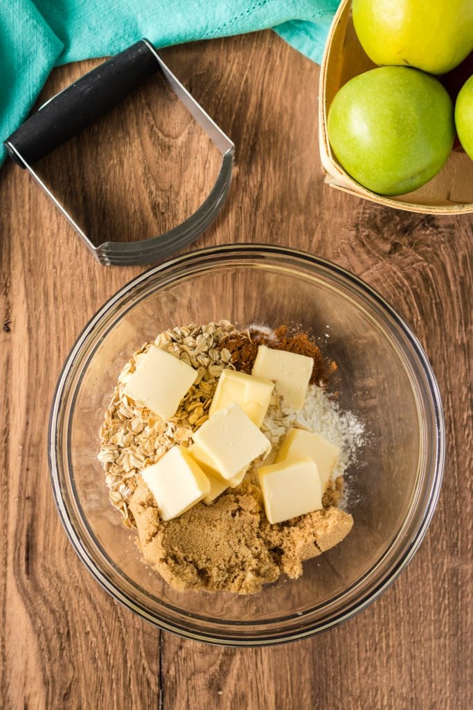 overhead shot of bowl making apple crisp cinnamon oat topping
