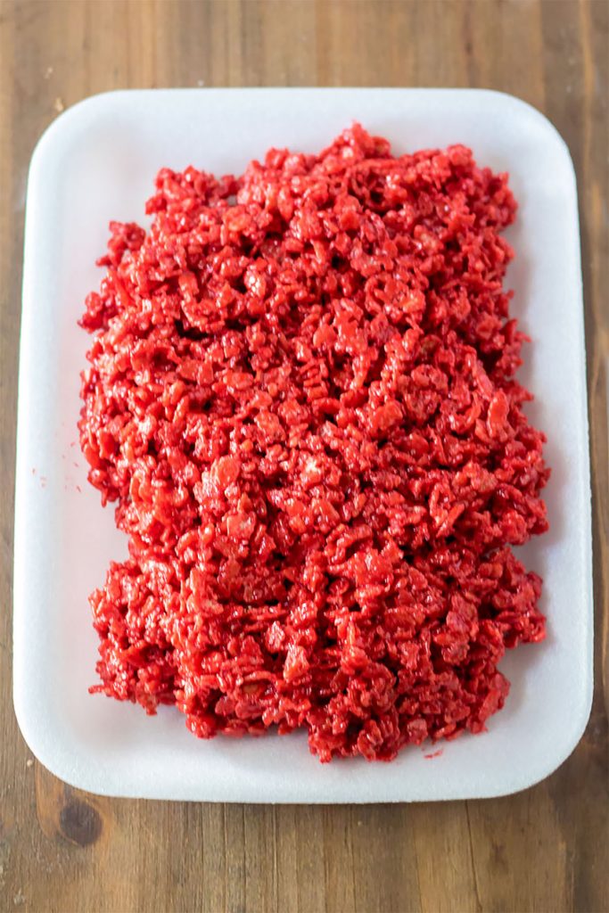 overhead shot of red velvet rice krispies on a white foam tray