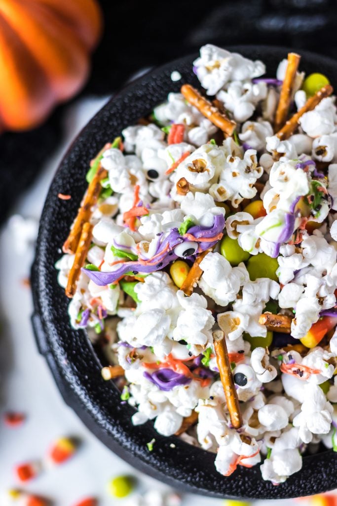overhead shot of cauldron filled with halloween popcorn mix