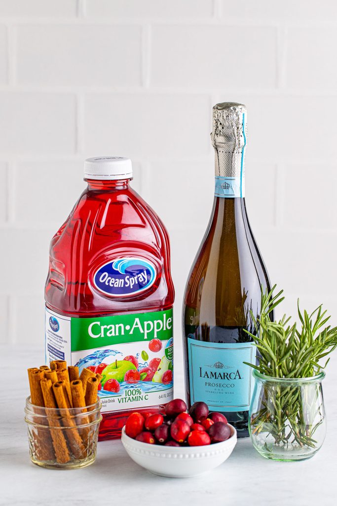 cran apple juice, prosecco, and cinnamon sticks to make christmas cocktails