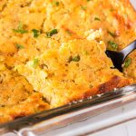 green chile corn casserole being lifted from a baking dish