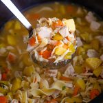 ladle scooping leftover turkey soup from the crockpot