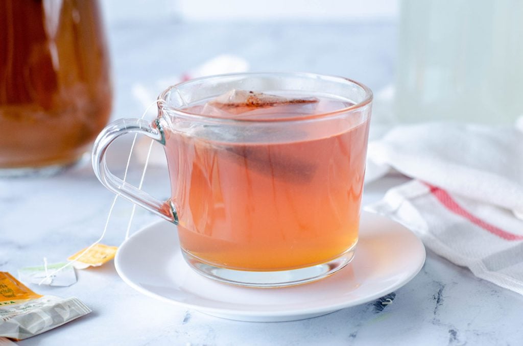 clear glass mug of medicine ball tea