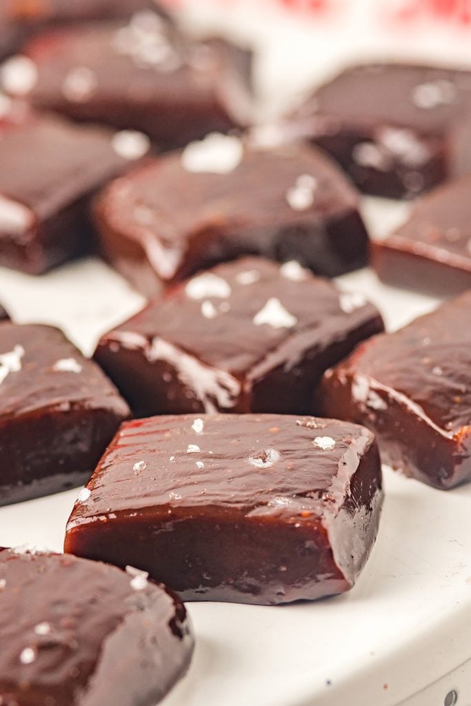 chocolate espresso caramels topped with sea salt on a white platter