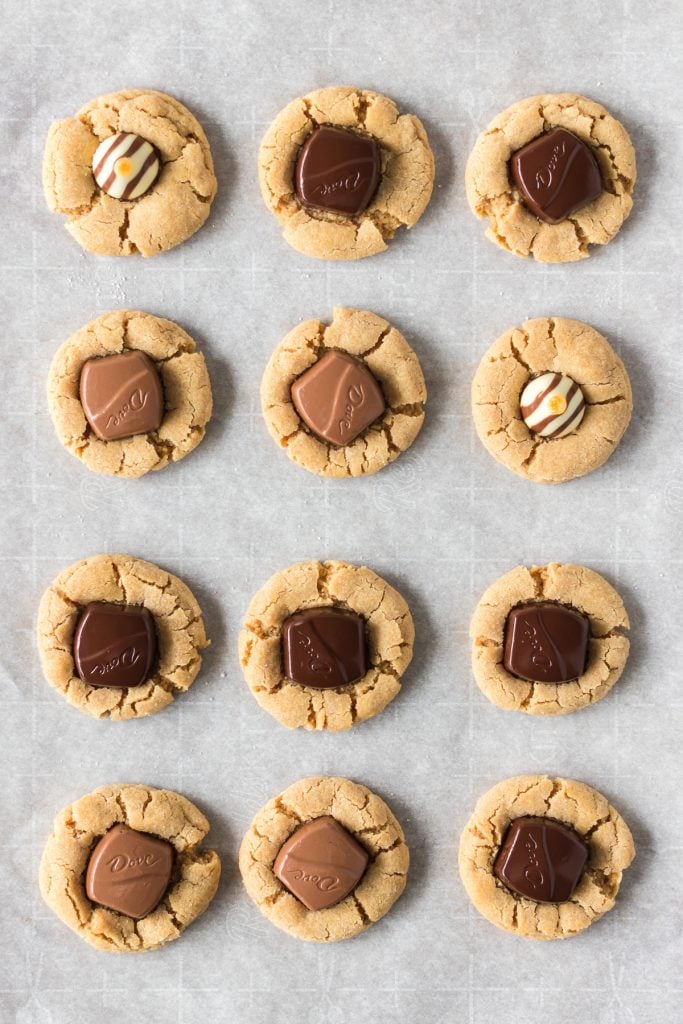 overhead shot of peanut butter blossoms topped with dove chocolates, hershey's bells, and hershey's hugs