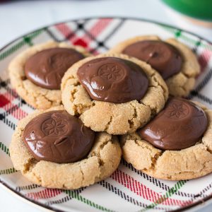 plaid plate holding a stack of peanut butter blossoms