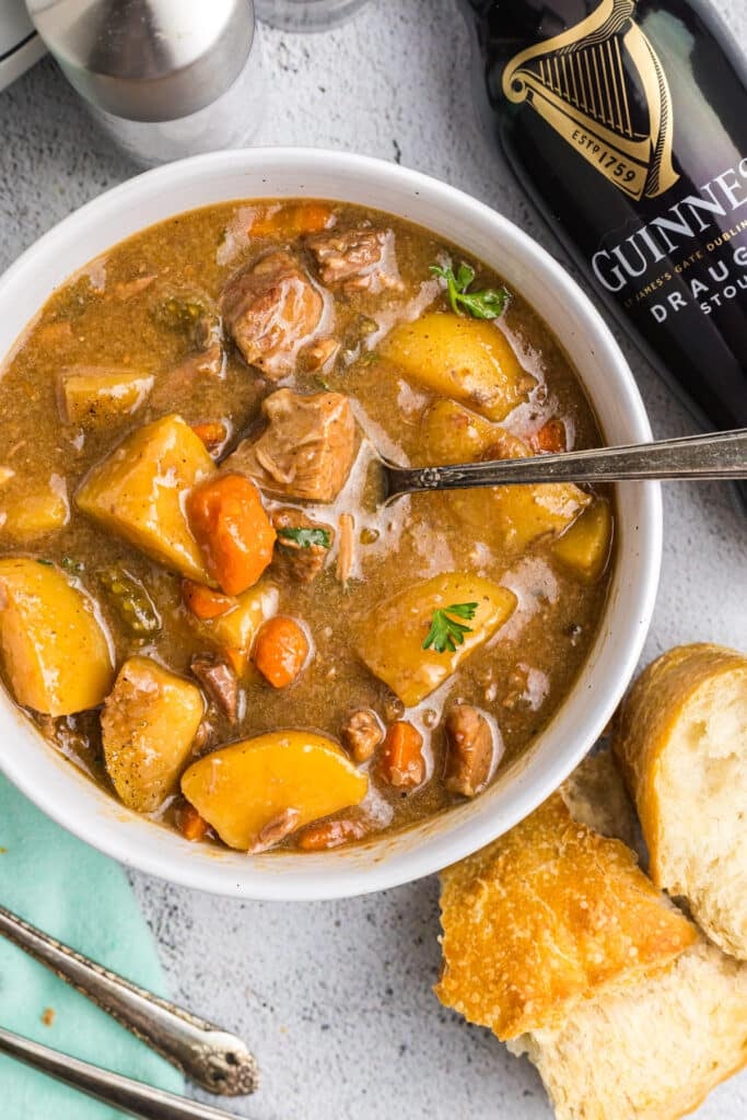 bowl of guinness beef stew with a piece of bread.