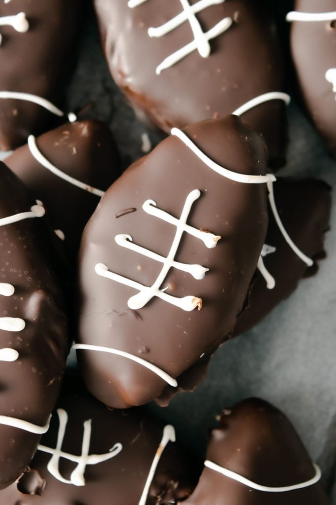 closeup of chocolate football with white chocolate laces.