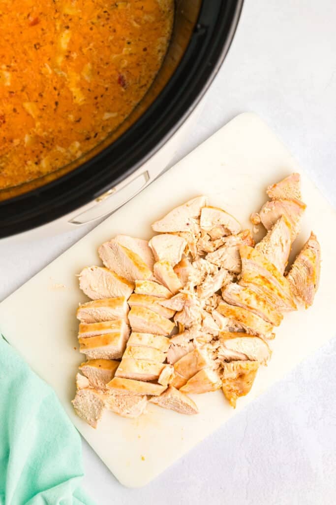 sliced chicken breast on a cutting board.