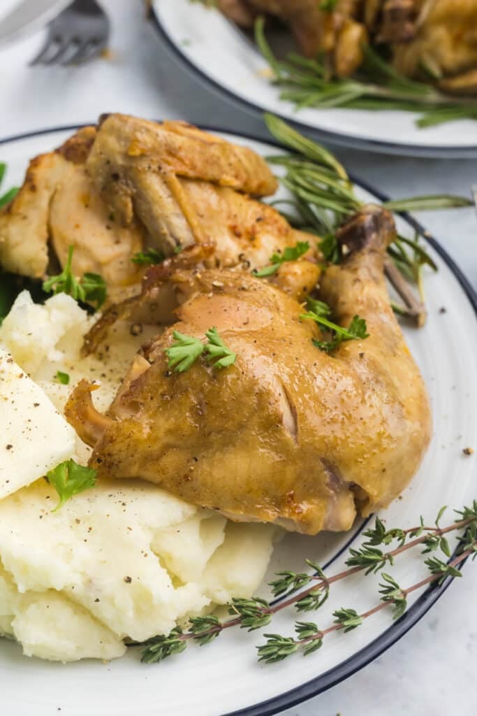 Cornish hen leg with mashed potatoes and herbs.