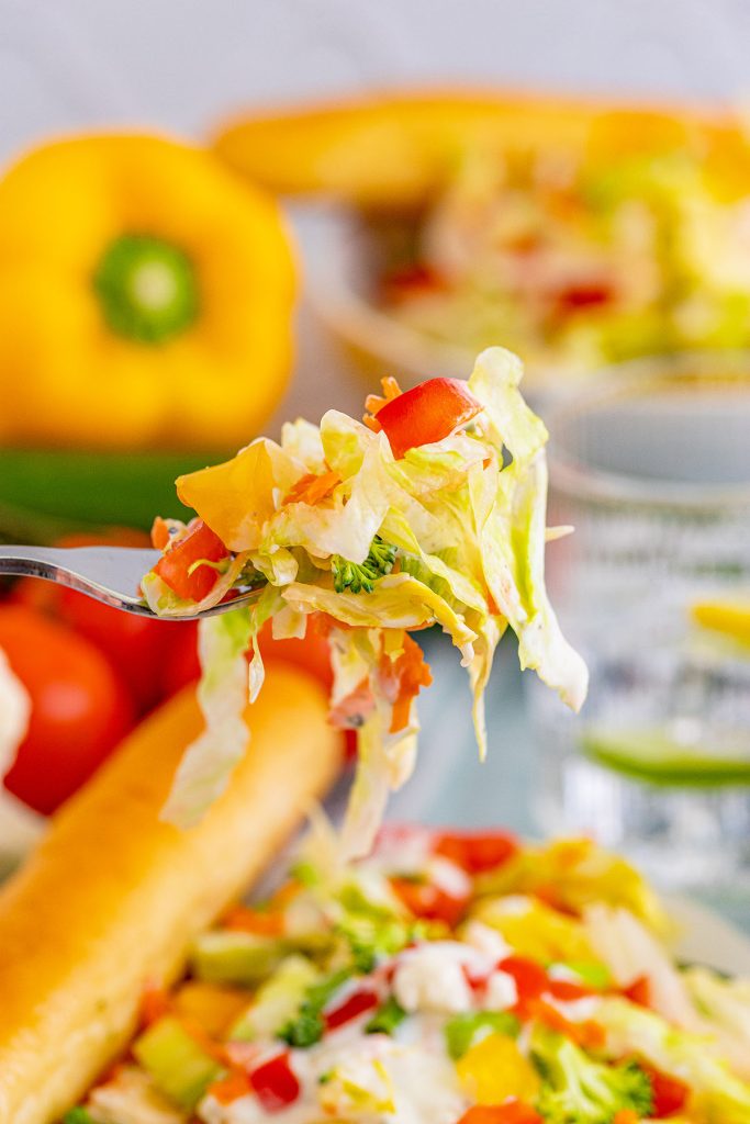 forkful of salad being lifted from a bowl.