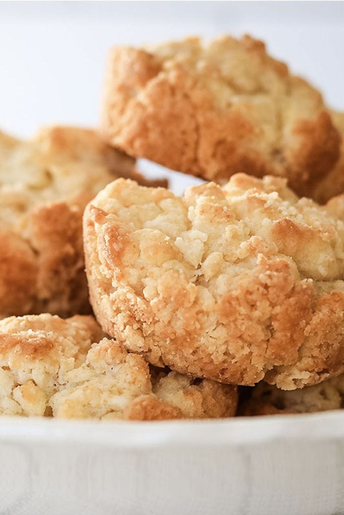 closeup of sour cream drop biscuits in a bowl.