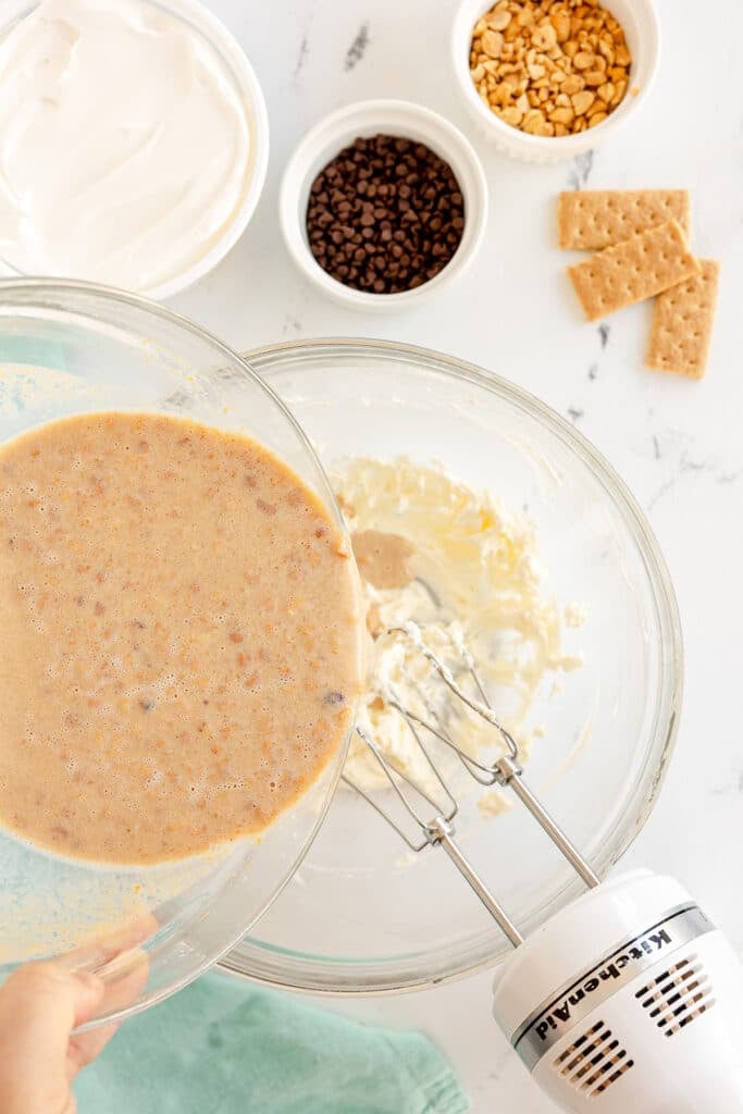 peanut butter mixture pouring into a mixing bowl.