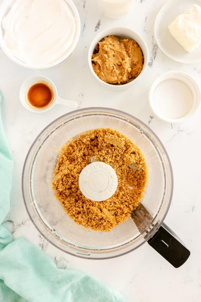 overhead shot of graham cracker crumbs in a food processor.