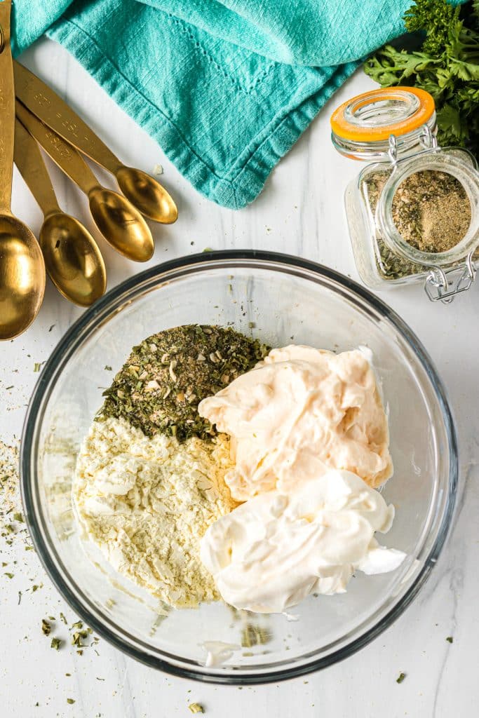 overhead shot of homemade ranch dressing ingredients in a mixing bowl.