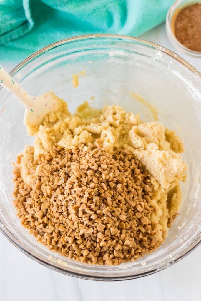 overhead shot of cookie dough in a glass mixing bowl.