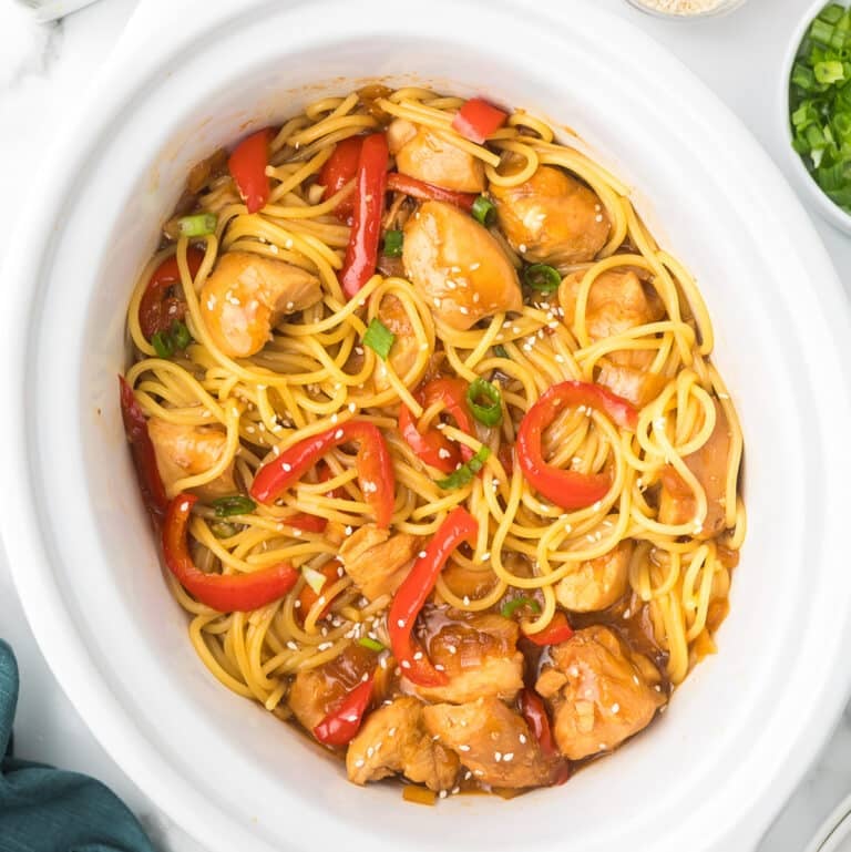 honey garlic chicken & noodles in a white slow cooker.