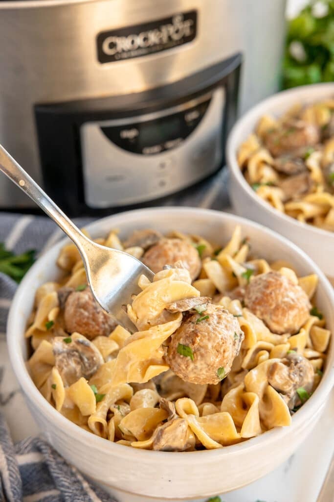 fork grabbing a bite of meatball and noodles.