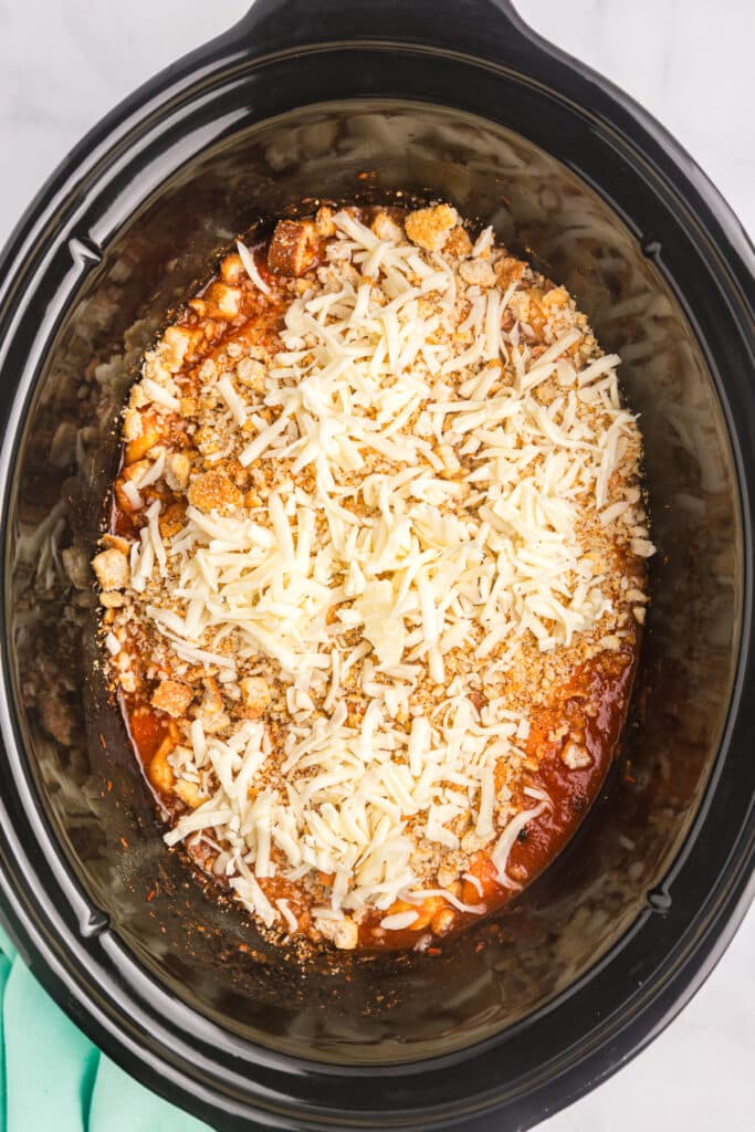 shredded mozzarella sprinkled in crockpot.